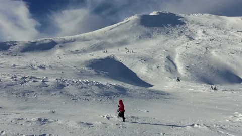 Aerial view of snow mountain range landscape. Climber Walking Up Mountain Exp Stock Footage 164722735