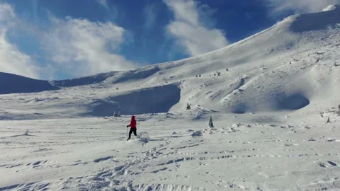 Aerial view of snow mountain range landscape. Climber Walking Up Mountain Exp Stock Footage 164863693