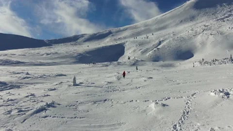 Aerial view of snow mountain range landscape. Climber Walking Up Mountain Exp Stock Footage 165663306