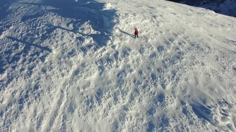 Aerial view of snow mountain range landscape. Climber Walking Up Mountain Exp Stock Footage 165663309