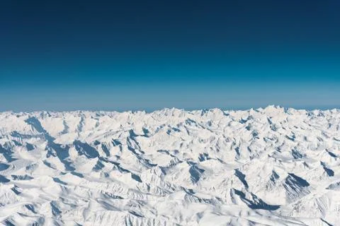 Aerial view of snow mountain range clear blue sky Stock Photos