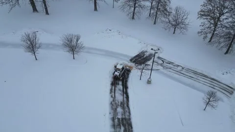 Aerial View of Snow Plow Clearing Parking Lot After Winter Storm Stock-Footage 332386584