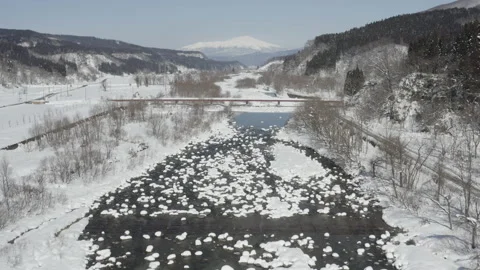 Aerial view of a snow rock river. Yamagata in winter surrounded by snow. Stock Footage 201259750