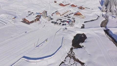 Aerial view of snow-surrounded restaurant on Austria cross-country ski trail Stock Footage 313367745