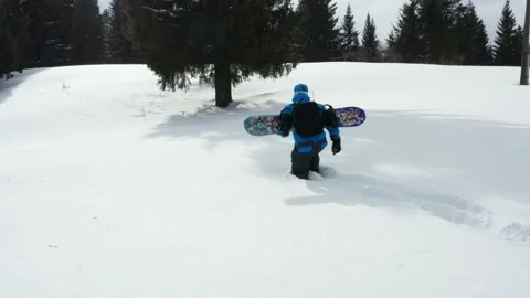 Aerial view of a snowboard going uphill near the village at sunset 動画素材 150903611