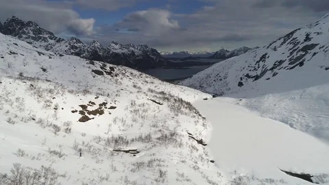 Aerial view of snowboarder freeride down from a summit of a winter mountain Stock Footage 78736930