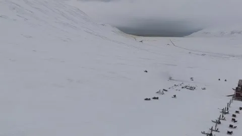 Aerial View of Snowmobile Returning to Dog Sled Base Reflecting Arctic Routine Stock Footage 345329081