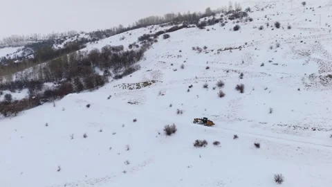 Aerial view of snowplow removing deep snow from mountain road 스톡 동영상 332368329