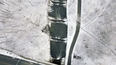 Aerial View of Snowy Bridge Over a Stream in Winter Landscape Stock Footage 293956231