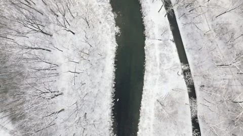 Aerial View of Snowy Bridge Over a Stream in Winter Landscape Stock Footage 293956491