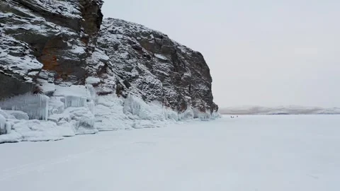 Aerial view of snowy cliffside with icicles, Russia. Stock Footage 314041565