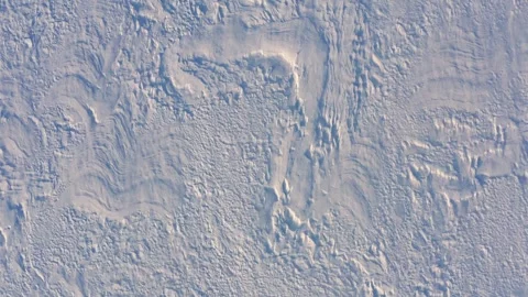 Aerial view of a snowy field with a strong wind Stock Footage 300151153