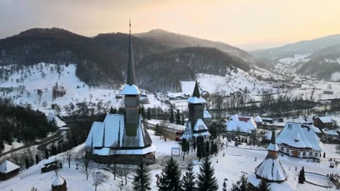 Aerial view of a snowy monastery in winter, revealing historic wooden churc.. Видео 339214318
