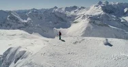 Aerial View Of Snowy Mountains With Person On Top Stock Footage
