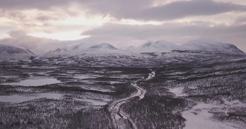 Aerial View of Snowy Mountains, RIver, and Forest Stock Footage