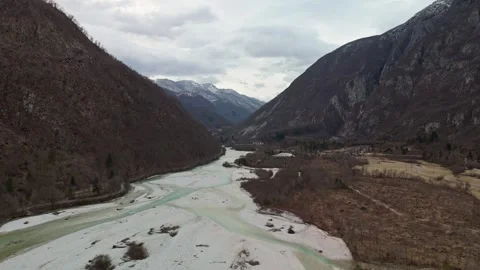 Aerial view of Soča River winding below snowy Julian Alps, Slovenia winter Video stock 340587976