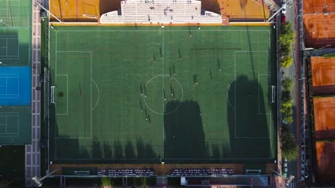 Aerial view of a soccer field while the silhouettes of the team players running Video stock 218240548