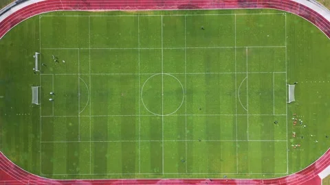 Aerial view of a soccer training session on a green football field with players Stock Footage 309869185