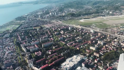 Aerial view of Sochi coastline and city blocks during spring, filmed from an Stock Footage 342030982
