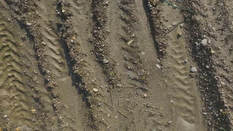 Aerial View Soil with Visible Tractor Tracks in an Open Farm Field Captured Stock Footage 300983799