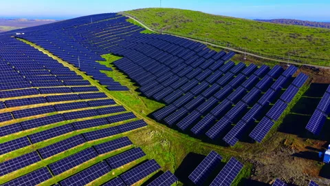 Aerial view of solar array covering green hillside Video stock 340407405
