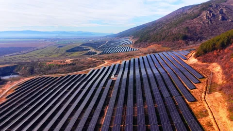 Aerial view of solar array descending mountain slope, Bulgaria Video stock 341758745