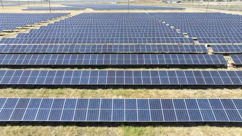 Aerial view of solar array farm on dry grass in Central California Stock Photos