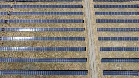 Aerial view of solar array farm on dry grass in Central California Stock Photos