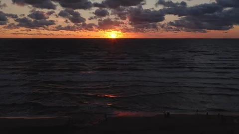 Aerial view of solar eclipse during sunset over ocean with waves Vídeo Stock 342172668