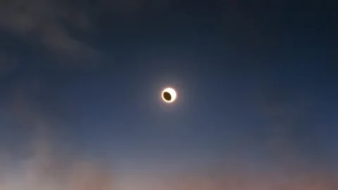 Aerial View of a Solar Eclipse at Sunset 動画素材 305768900