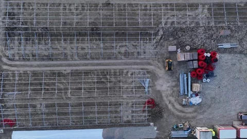 Aerial view of solar farm construction with mounting structures and materials Stock Footage 332784571