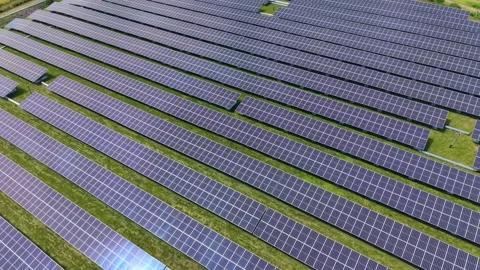 Aerial view of solar panel array in green field Video stock 339762616