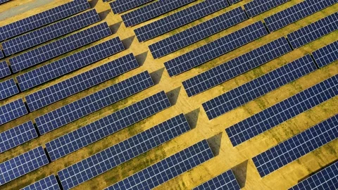 Aerial view of a solar panel farm with rows of panels drawing energy from the Stock Footage 147406556