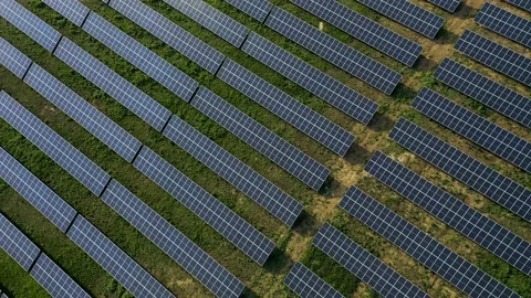 Aerial view of a solar panel farm with rows of panels drawing energy from the Stock Footage 153167634