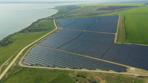 Aerial view of a solar panel farm with rows of panels drawing energy from the Stock Footage 153242218