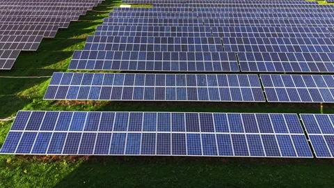 Aerial view of a solar panel farm capturing sunlight Stock Footage 325090375