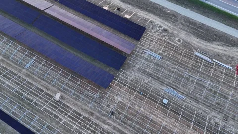 Aerial view of solar panel farm construction and mounting process Stock Footage 332781817
