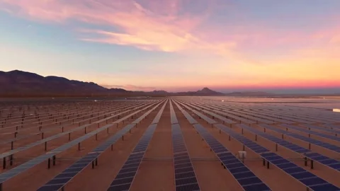 Aerial view of solar panel farm in desert at sunset with purple sky. Stock Footage 337442792