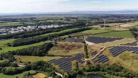 Aerial view of solar panel farm and wind turbine generating clean energy Stock Footage 344751569