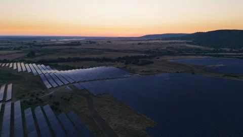 Aerial view of a solar panel farm producing renewable energy at sunset Stock Footage 344759859