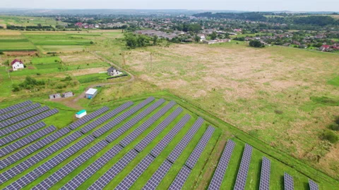 Aerial view of solar panel farm integrated into countryside farmland Stock Footage 346541061