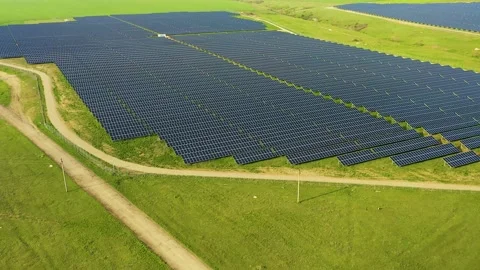 Aerial view of a solar panel field with rows of panels drawing energy from the Stock Footage 154556247