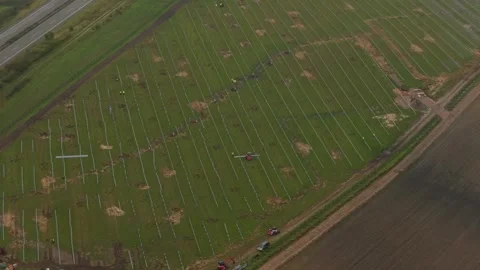 Aerial view of solar panel installation by crew on large farm in Germany Stock Footage 320246624