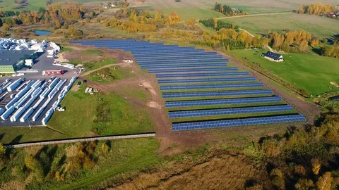 Aerial view of solar panel rows near a factory during Autumn, Estonia. Stock Footage 101569577