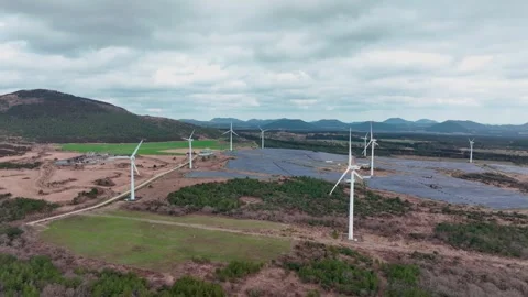 Aerial view of solar panels and wind turbines in Jeju Island Stock Footage 296434160