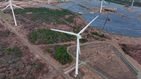 Aerial view of solar panels and wind turbines in Jeju Island Stock Footage 296435754
