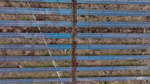 Aerial view of solar panels and wind turbines in Jeju Island Stock Footage 296437317