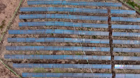 Aerial view of solar panels and wind turbines in Jeju Island Stock Footage 296443248