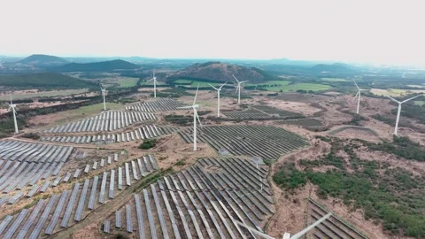 Aerial view of solar panels and wind turbines in Jeju Island Stock Footage 296443744