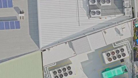 Aerial view of solar panels and hvac units on an industrial rooftop Stock Footage 340576128